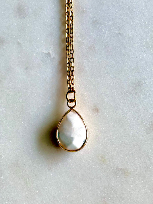 Necklace with a teardrop-shaped pendant on a light gray background
