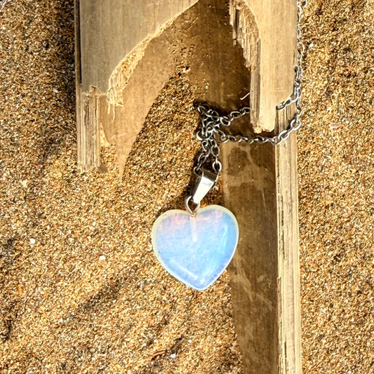 Necklace with a heart-shaped pendant on a wooden background